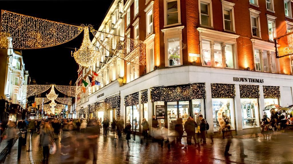 Crowds shopping at night on a lit up Grafton Street
